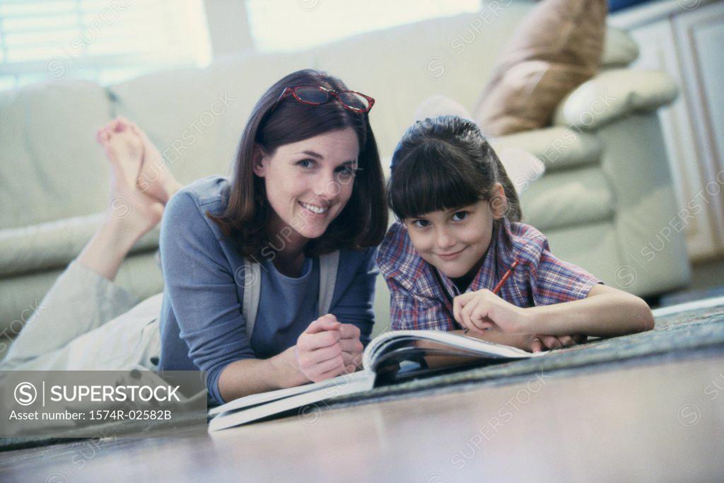Stock Photo: 1574R-02582B Mother assisting her daughter with her homework