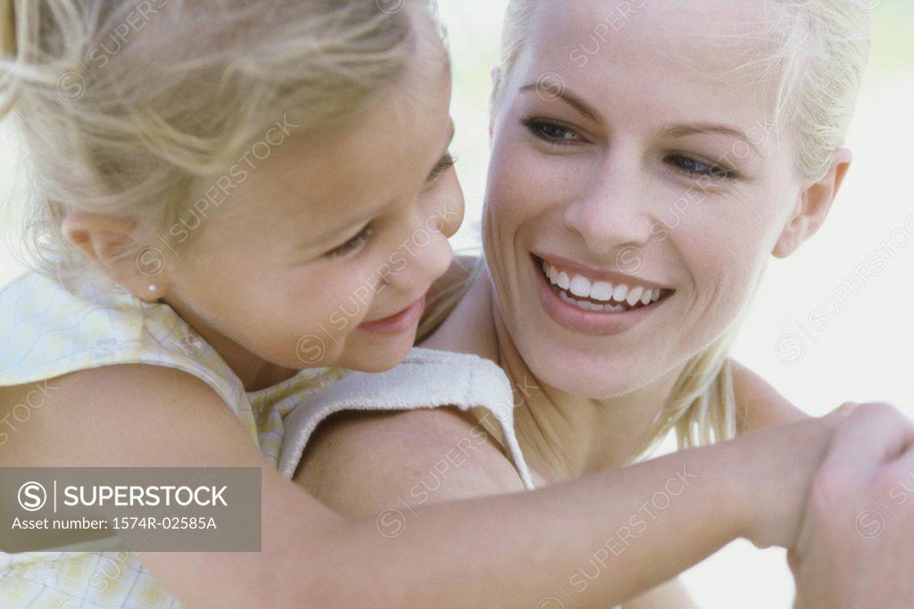 Stock Photo: 1574R-02585A Girl riding piggyback on her mother