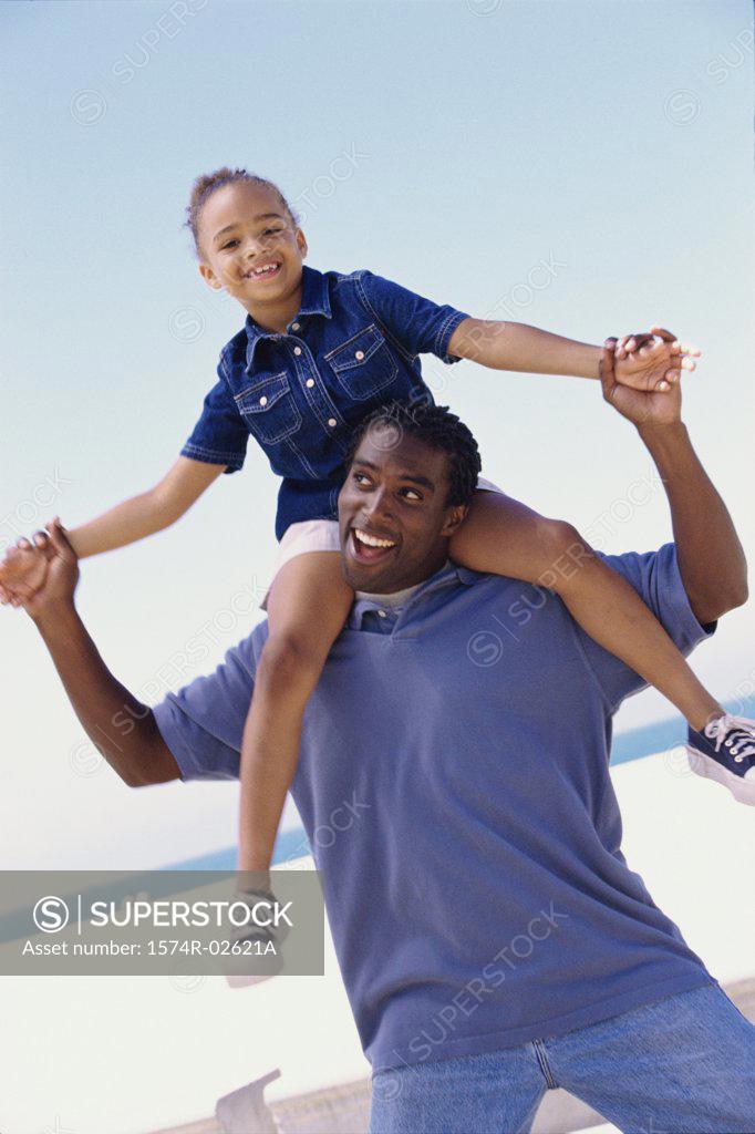 Stock Photo: 1574R-02621A Portrait of a father carrying his daughter on his shoulders