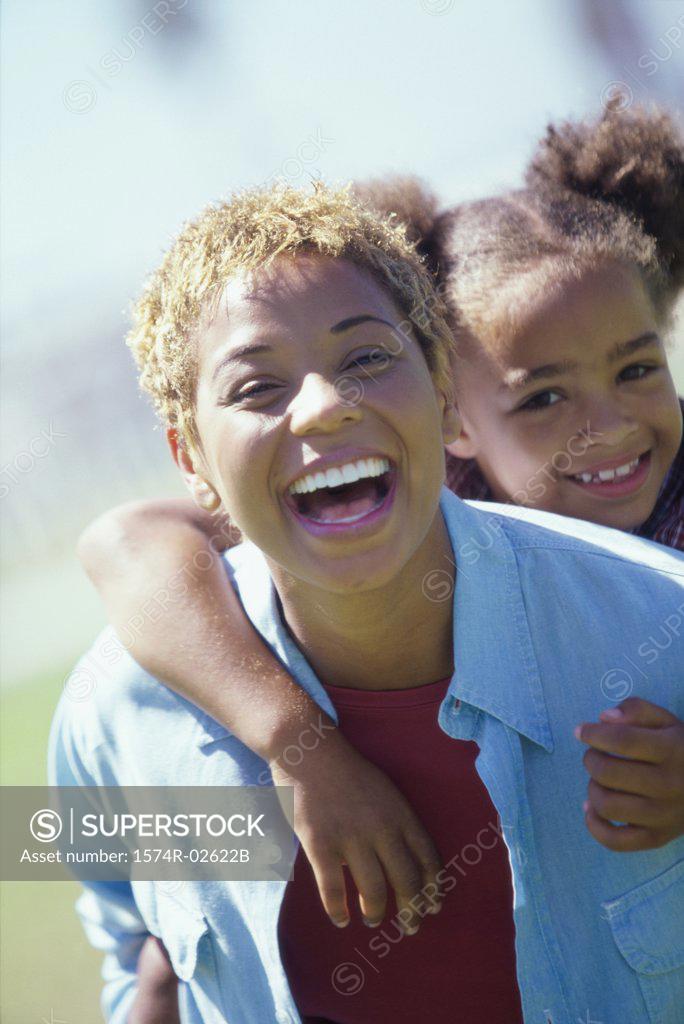 Stock Photo: 1574R-02622B Portrait of a girl riding piggyback on her mother