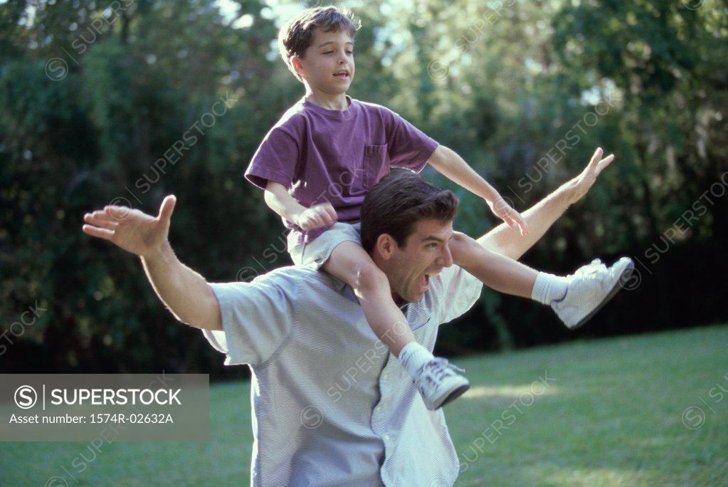 Stock Photo: 1574R-02632A Father carrying his son on his shoulders