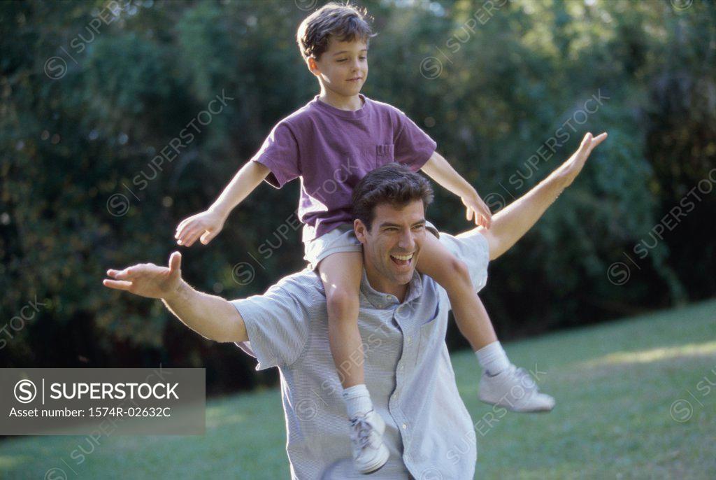 Stock Photo: 1574R-02632C Father carrying his son on his shoulders