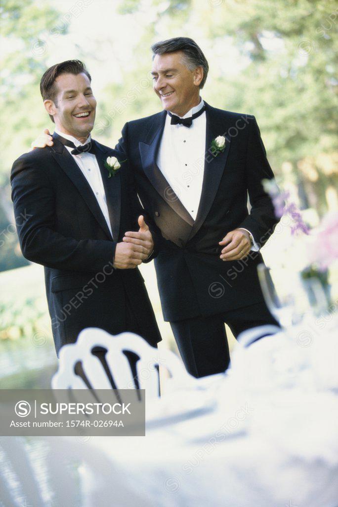 Stock Photo: 1574R-02694A Newlywed young man talking with his father