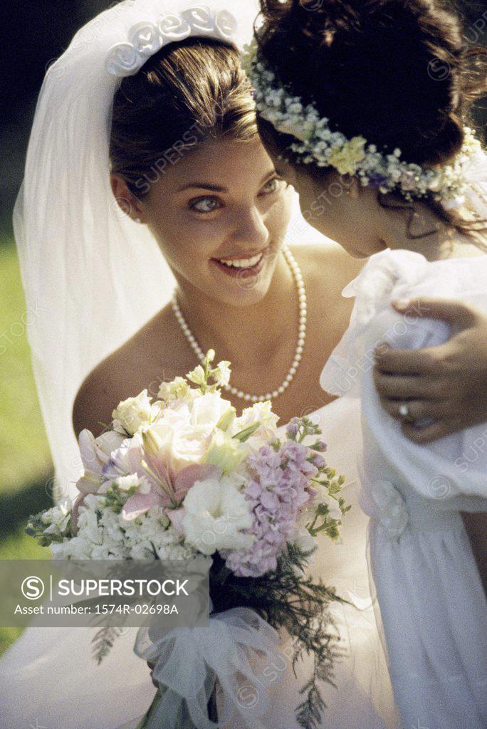 Stock Photo: 1574R-02698A Close-up of a bride smiling at a flower girl