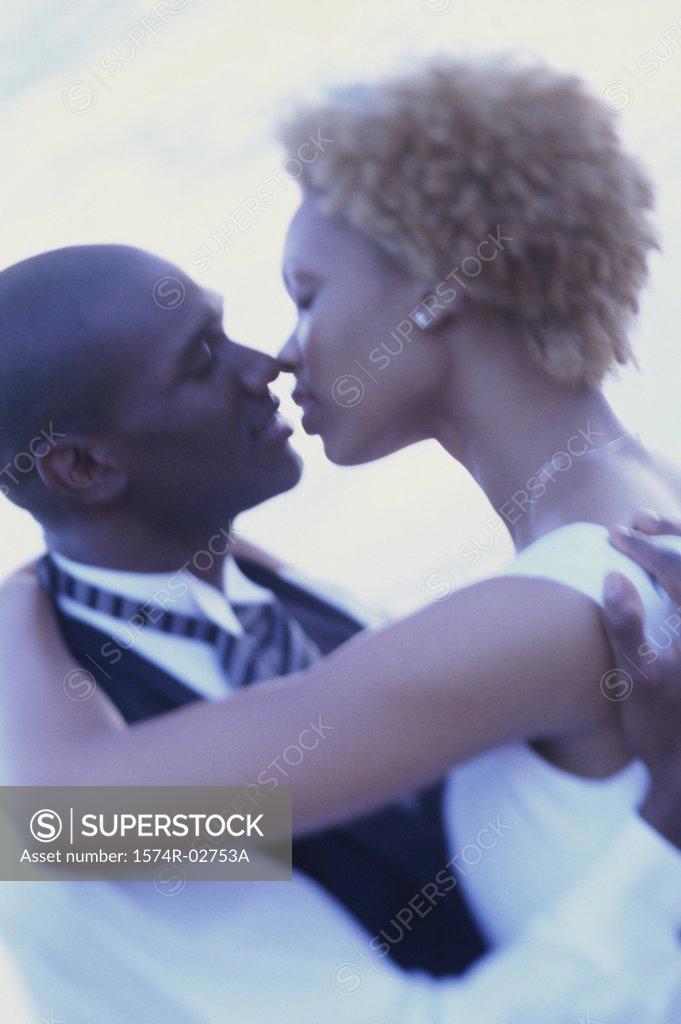 Stock Photo: 1574R-02753A Newlywed couple kissing each other