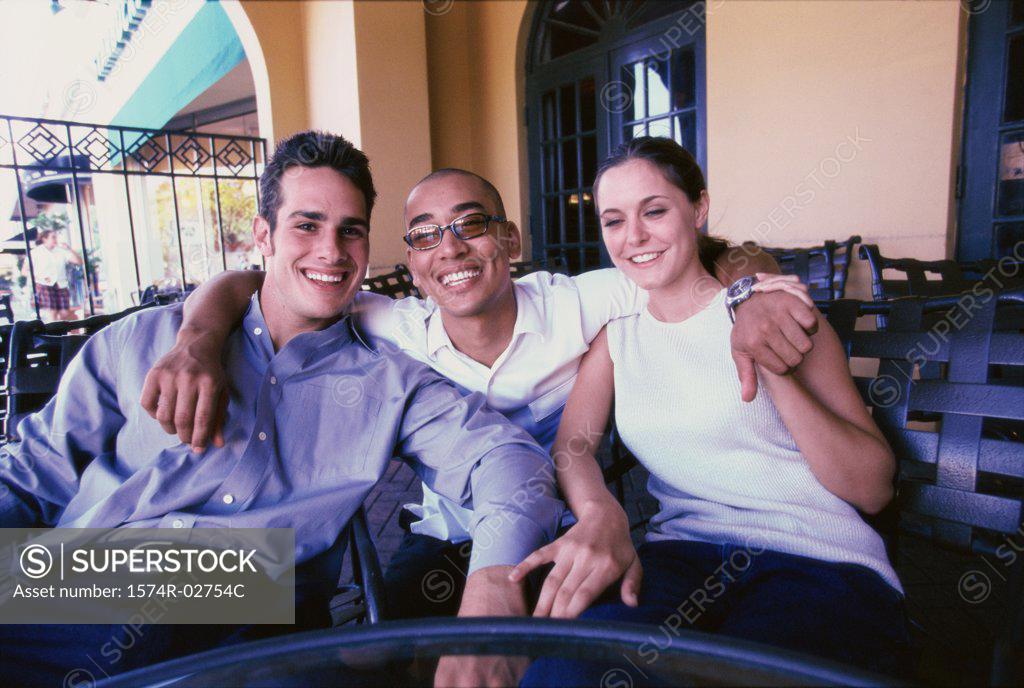 Stock Photo: 1574R-02754C Portrait of two young men and a young woman smiling
