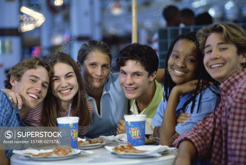 Stock Photo: 1574R-02757A Portrait of a group of teenagers sitting in a restaurant