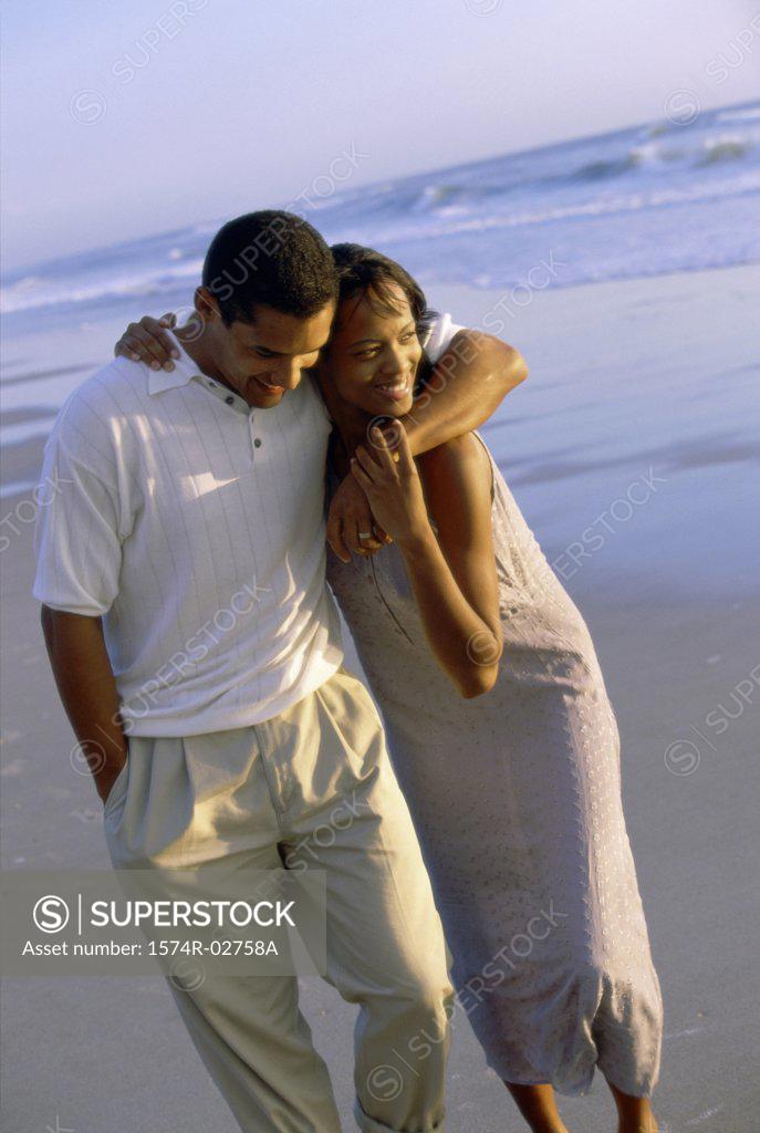 Stock Photo: 1574R-02758A Young couple walking on the beach