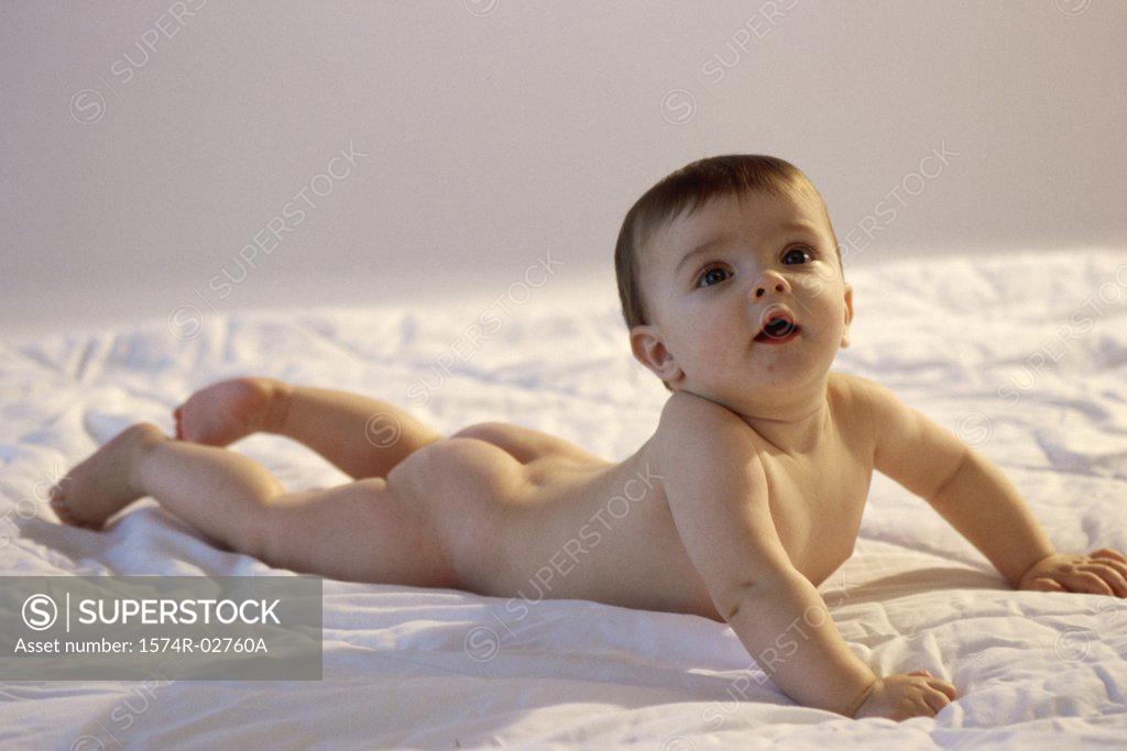 Stock Photo: 1574R-02760A Baby boy lying on a bed