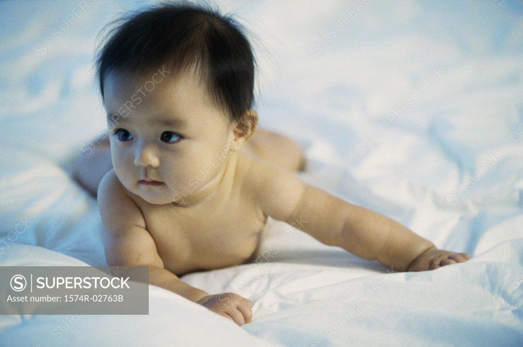 Stock Photo: 1574R-02763B Close-up of a baby boy lying on a bed