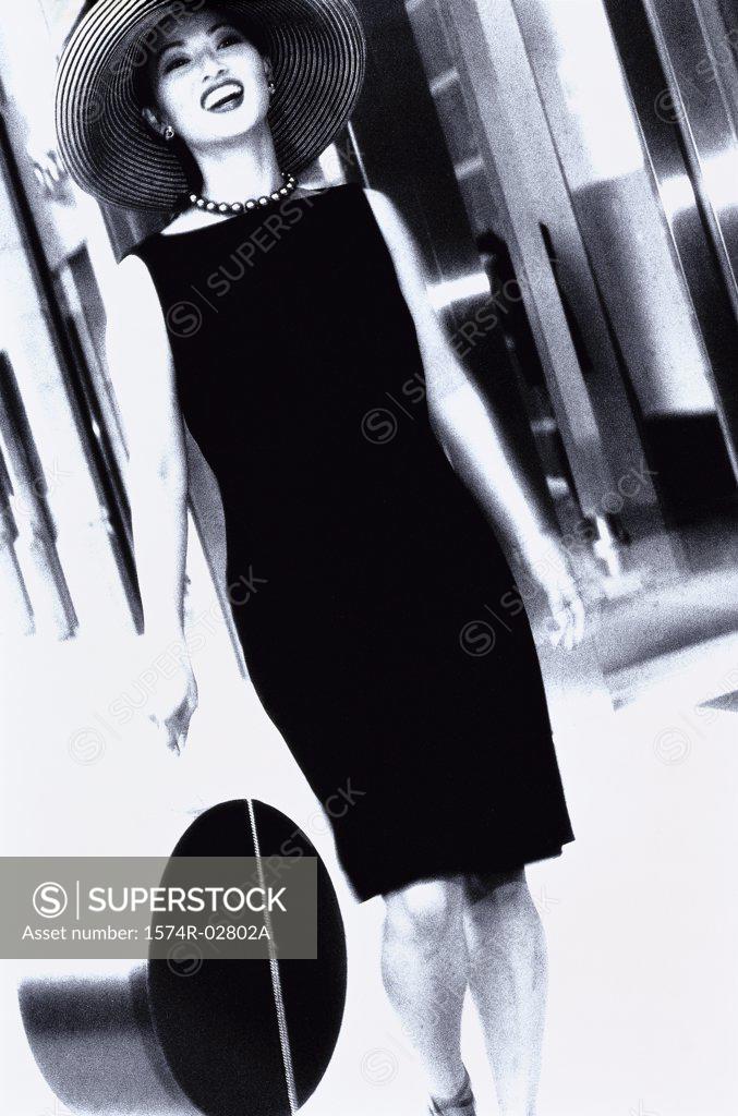 Stock Photo: 1574R-02802A Young woman carrying a bag