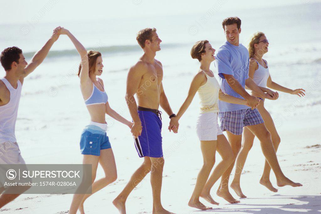 Stock Photo: 1574R-02806A Group of young people walking on the beach