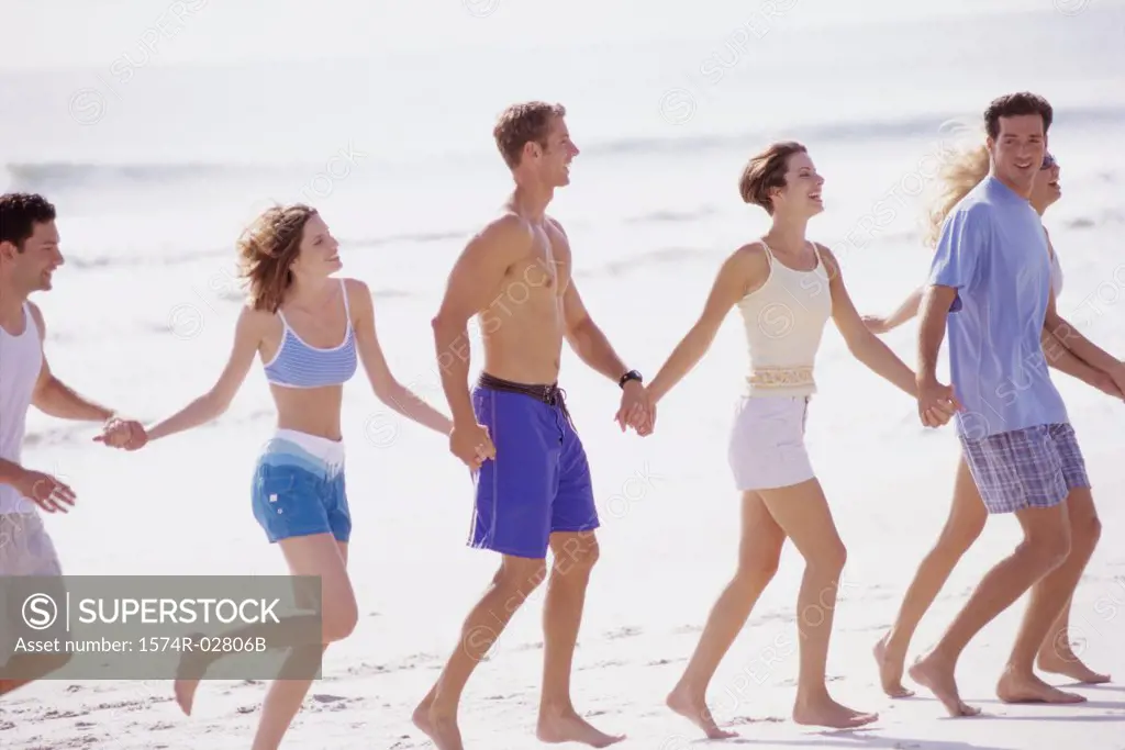 Group of young people walking on the beach
