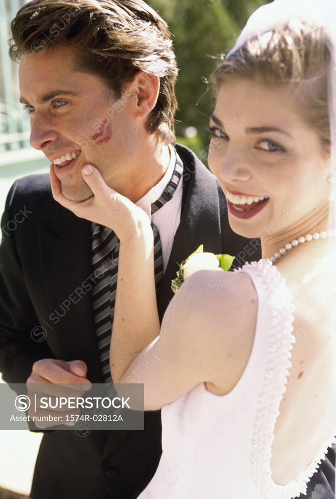 Stock Photo: 1574R-02812A Portrait of a bride holding her groom's face