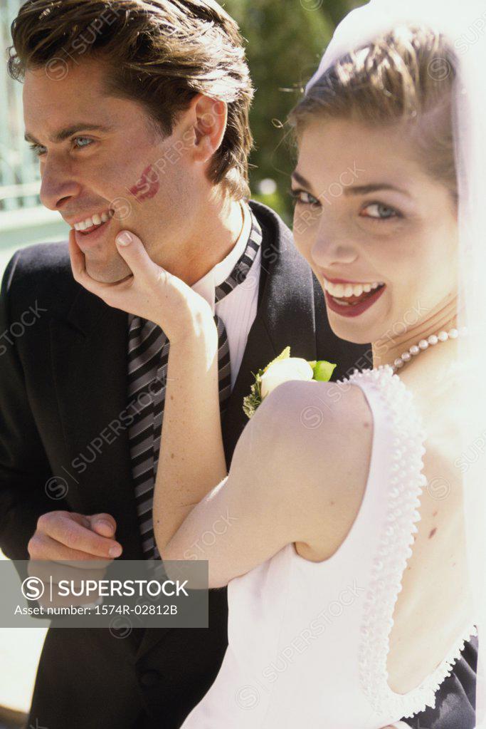 Stock Photo: 1574R-02812B Portrait of a bride holding her groom's face