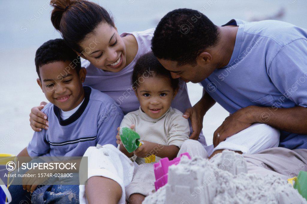 Stock Photo: 1574R-02880C Parents with their son and daughter on the beach