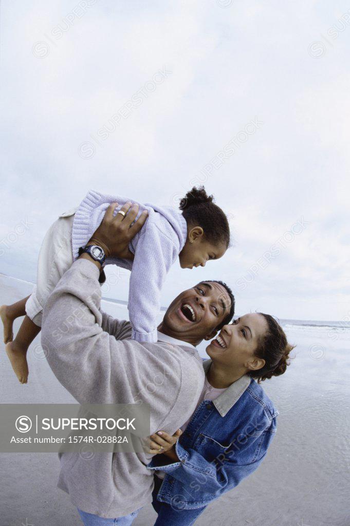 Stock Photo: 1574R-02882A Parents with their daughter on the beach
