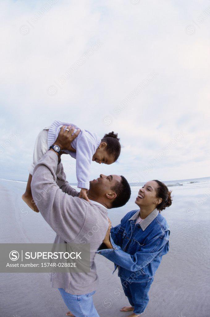 Stock Photo: 1574R-02882E Parents with their daughter on the beach
