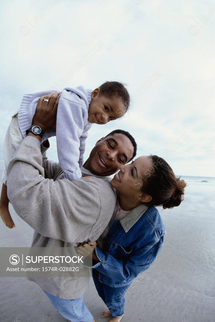 Stock Photo: 1574R-02882G Parents with their daughter on the beach