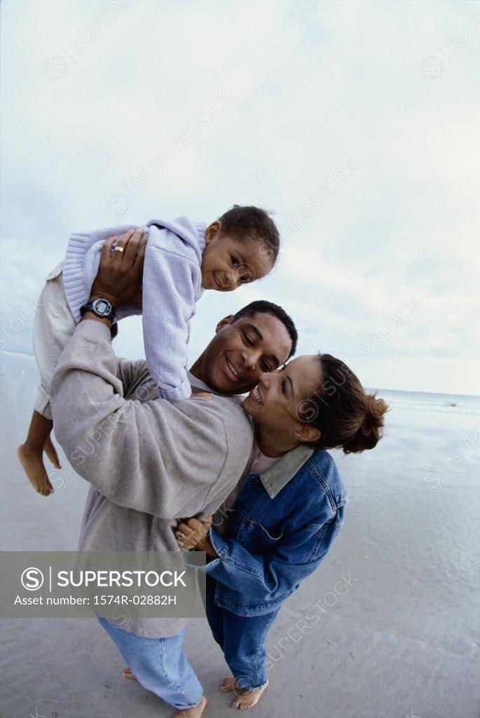 Stock Photo: 1574R-02882H Parents with their daughter on the beach