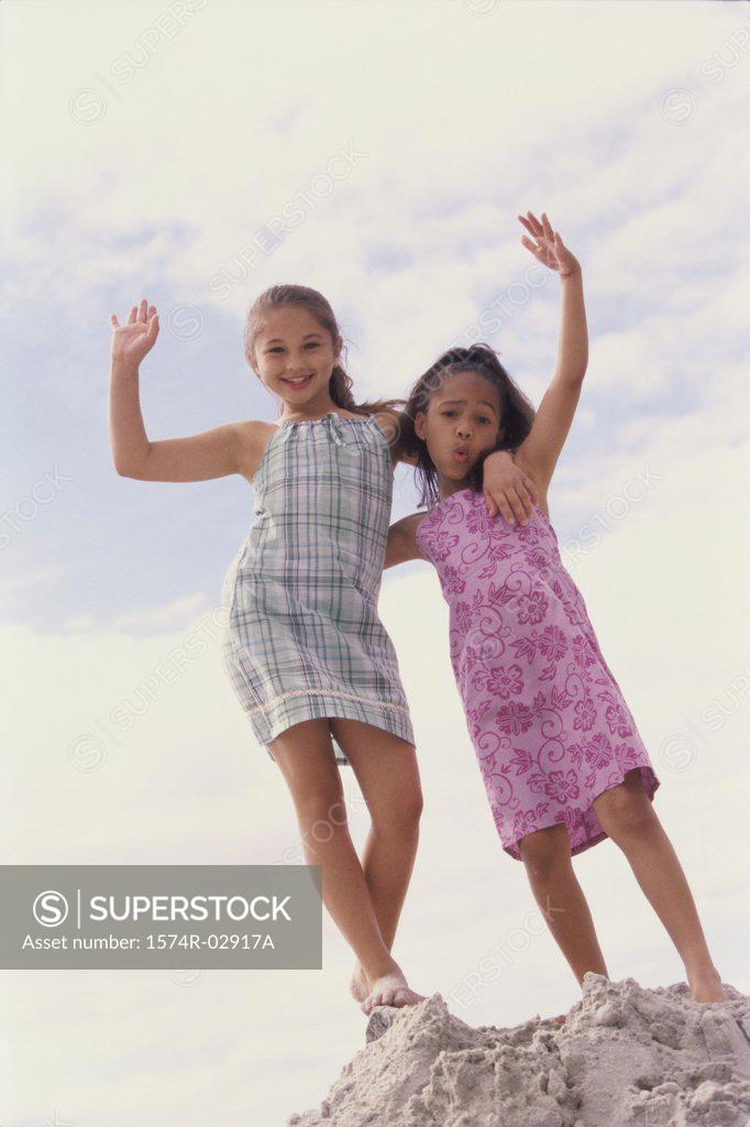 Stock Photo: 1574R-02917A Portrait of two girls standing on the beach