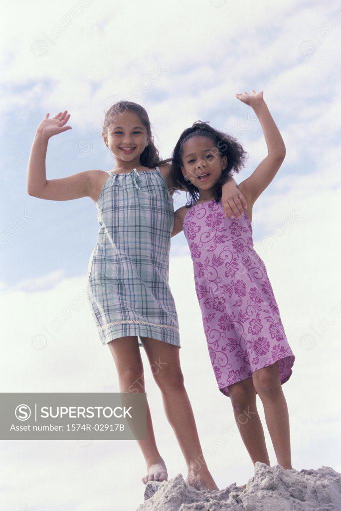 Stock Photo: 1574R-02917B Portrait of two girls standing on the beach