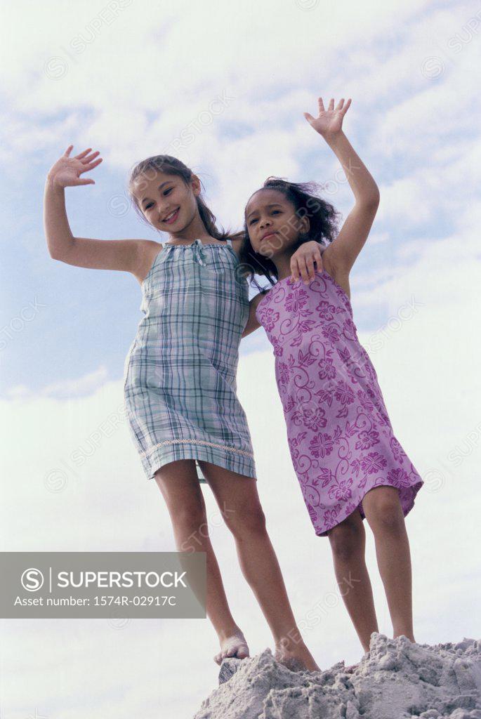Stock Photo: 1574R-02917C Portrait of two girls standing on the beach