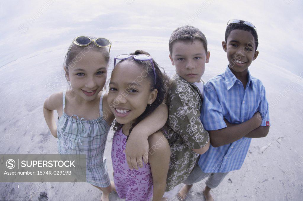 Stock Photo: 1574R-02919B Portrait of two boys and two girls standing on the beach