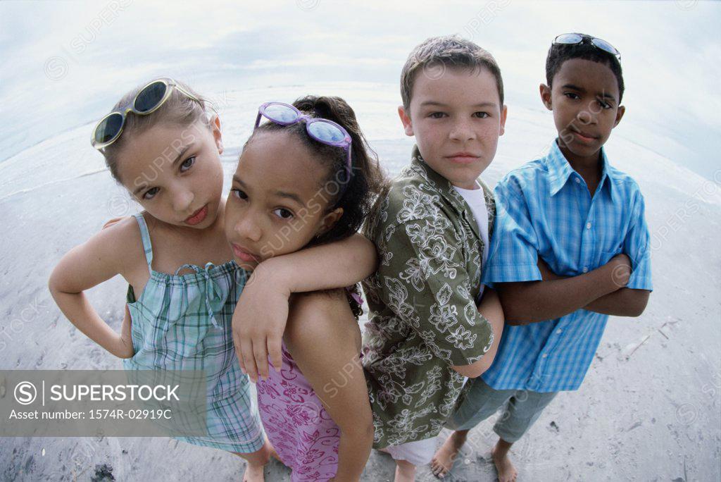 Stock Photo: 1574R-02919C Portrait of two boys and two girls standing on the beach