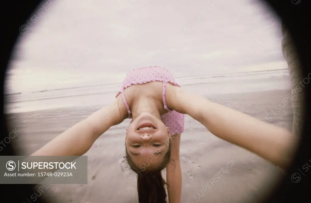 Girl bending over backwards on the beach
