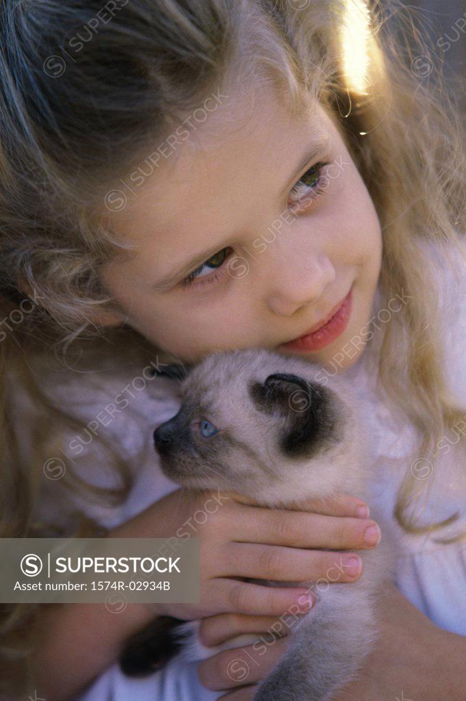 Stock Photo: 1574R-02934B Close-up of a girl holding a Siamese kitten