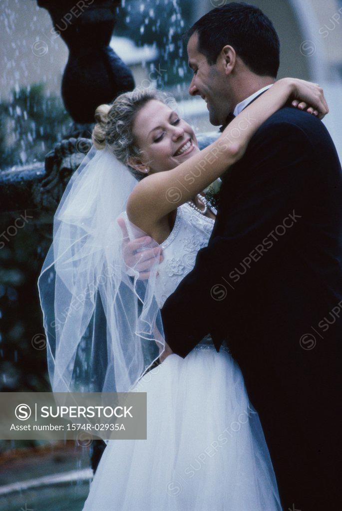 Stock Photo: 1574R-02935A Newlywed couple embracing each other