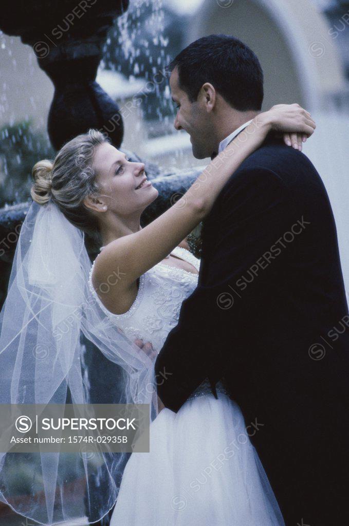 Stock Photo: 1574R-02935B Side profile of a newlywed couple embracing