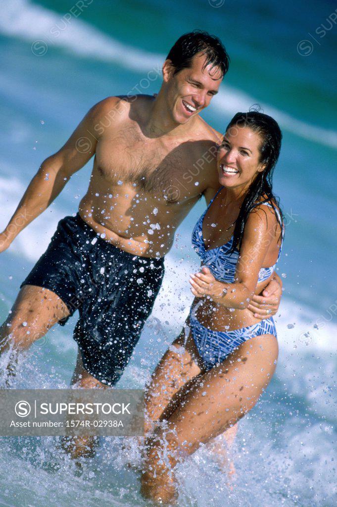 Stock Photo: 1574R-02938A Young couple running on the beach
