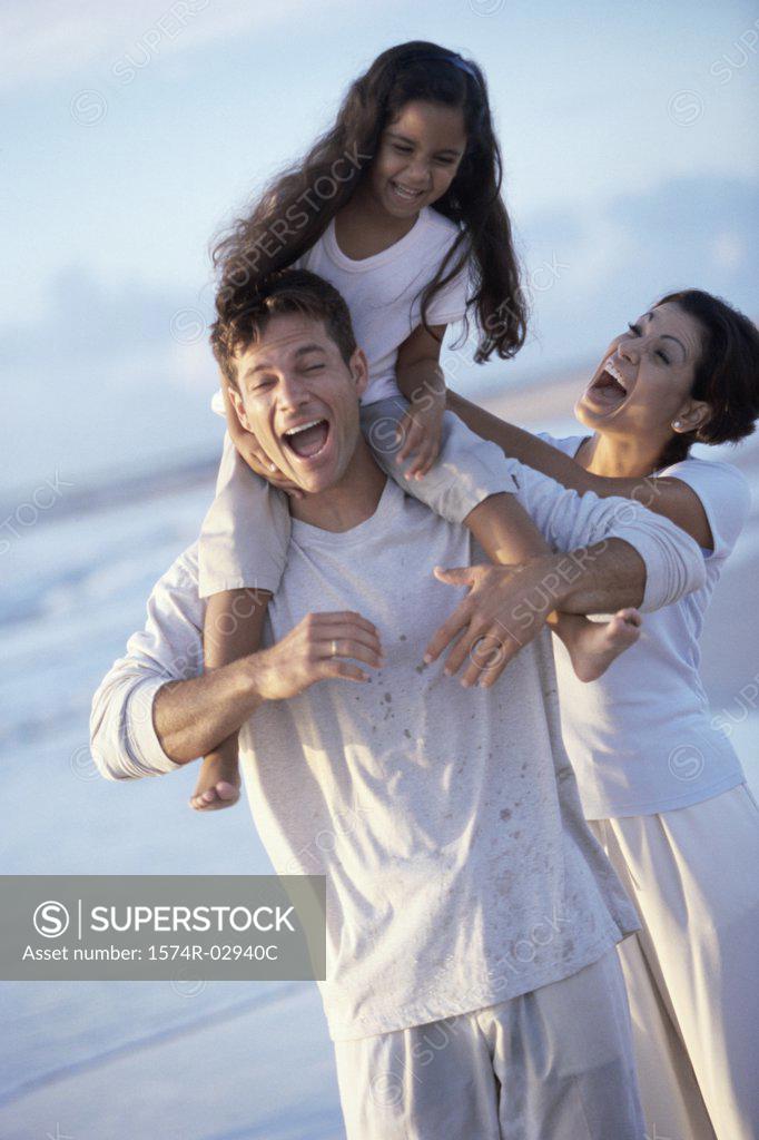 Stock Photo: 1574R-02940C Parents with their daughter on the beach