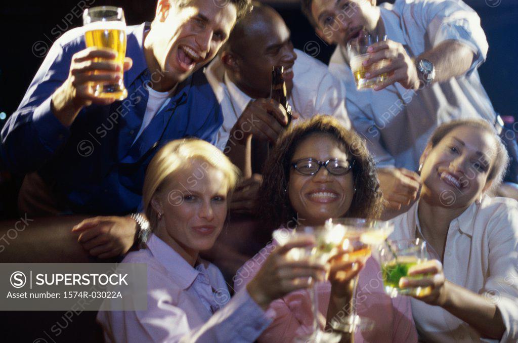 Stock Photo: 1574R-03022A Portrait of three young couples toasting with glasses