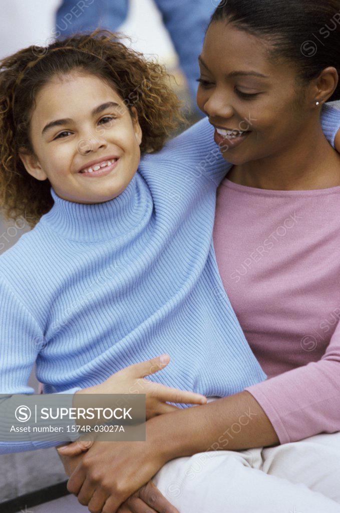 Stock Photo: 1574R-03027A Portrait of a mother carrying her daughter