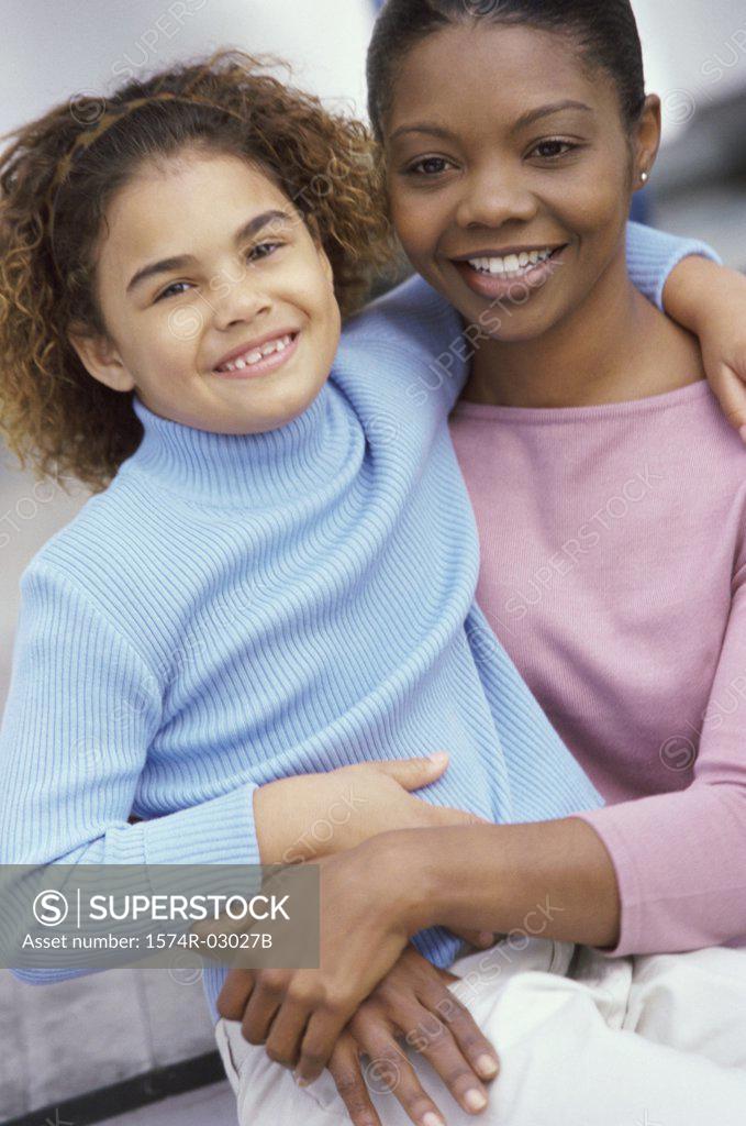 Stock Photo: 1574R-03027B Portrait of a mother carrying her daughter