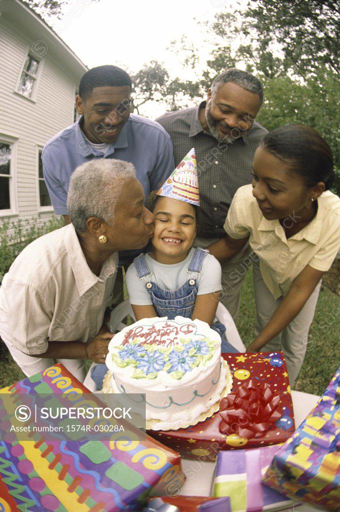 Stock Photo: 1574R-03028A Daughter celebrating her birthday with her parents and grandparents