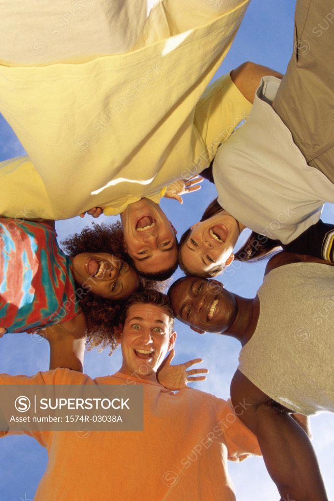 Stock Photo: 1574R-03038A Low angle view of a group of young people in a huddle