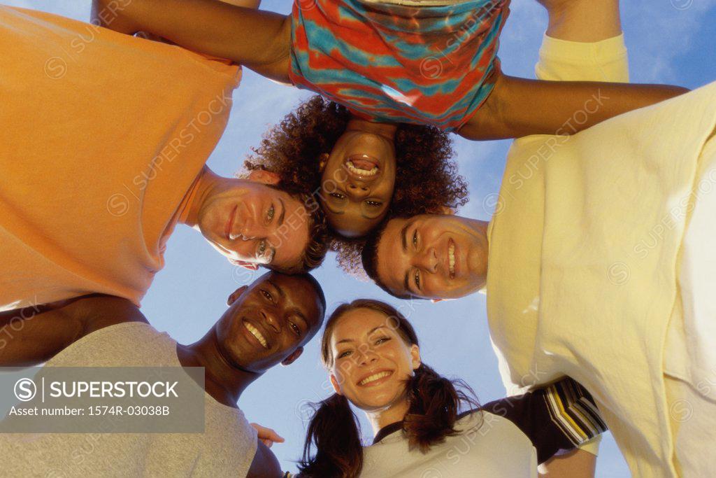 Stock Photo: 1574R-03038B Low angle view of a group of young people in a huddle