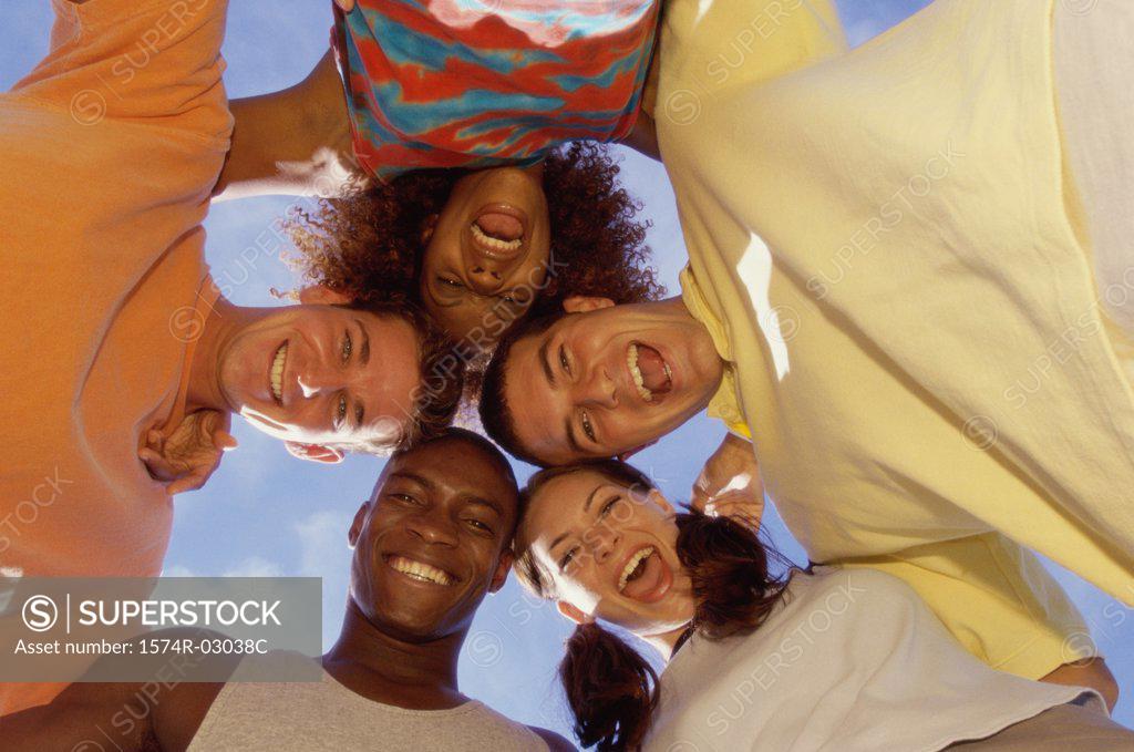 Stock Photo: 1574R-03038C Low angle view of a group of young people in a huddle