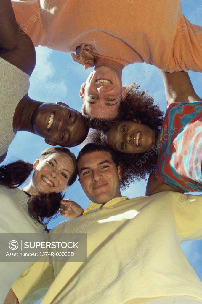 Stock Photo: 1574R-03038D Low angle view of a group of young people in a huddle