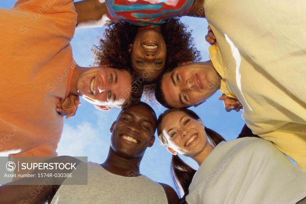 Stock Photo: 1574R-03038E Low angle view of a group of young people in a huddle