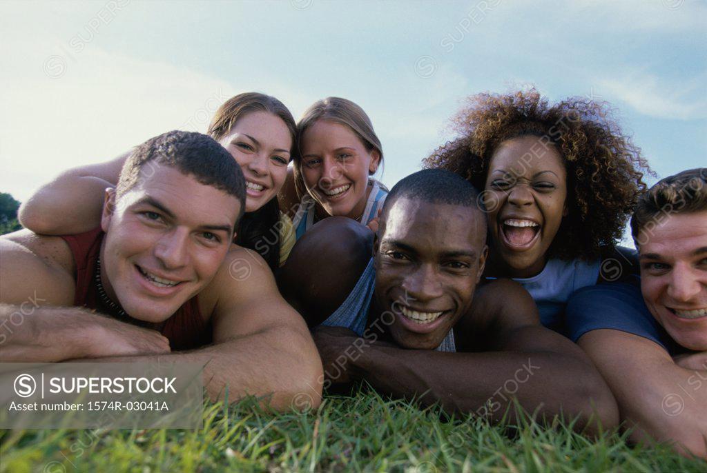 Stock Photo: 1574R-03041A Portrait of a group of young people lying on grass