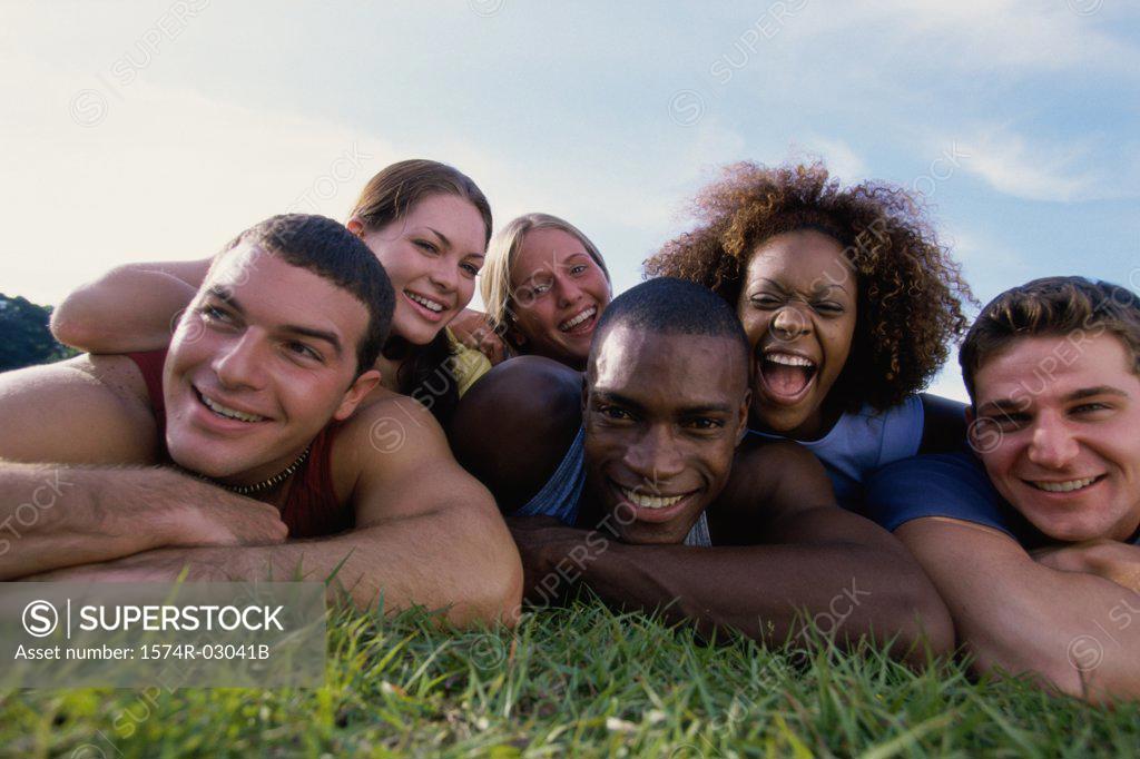 Stock Photo: 1574R-03041B Portrait of a group of young people lying on grass
