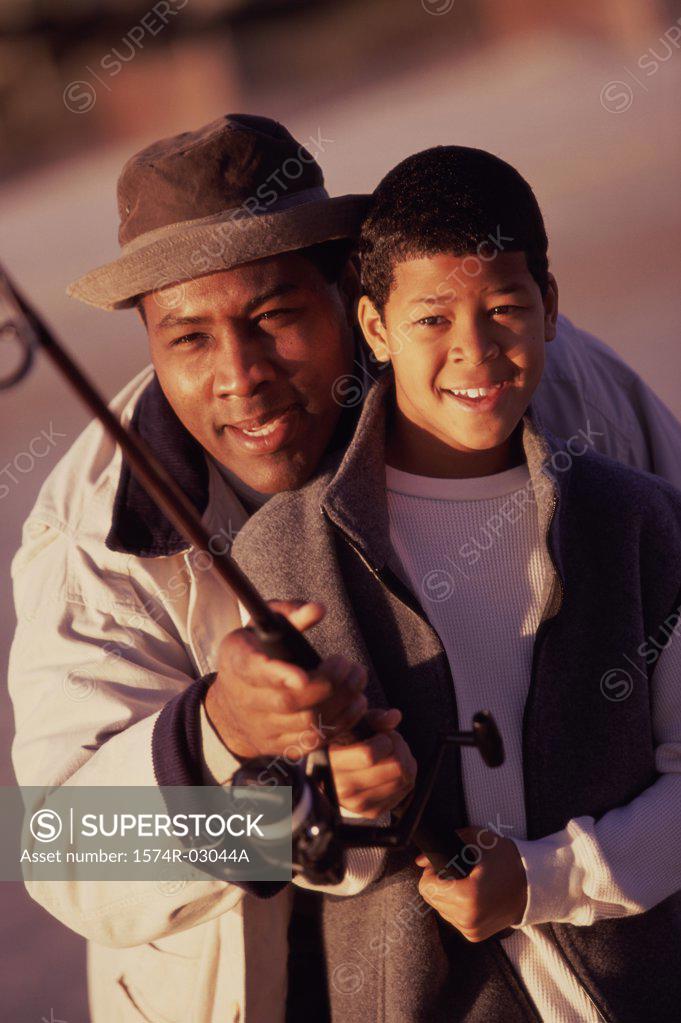 Stock Photo: 1574R-03044A Close-up of a father teaching his son fishing