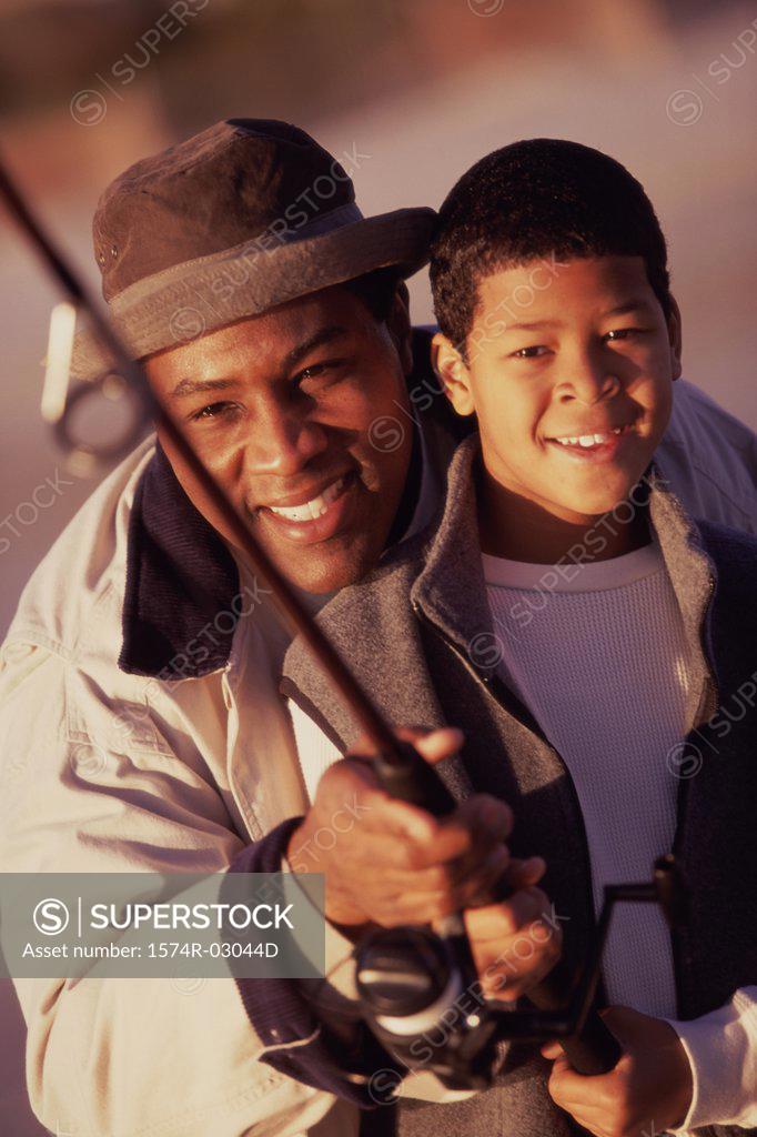Stock Photo: 1574R-03044D Close-up of a father teaching his son fishing