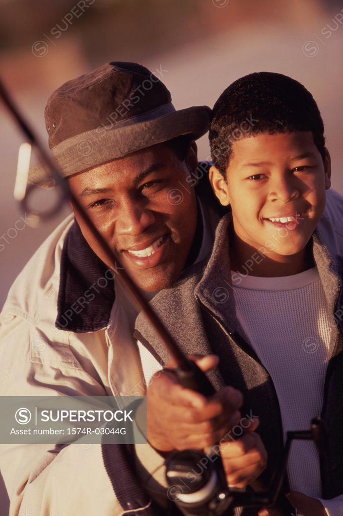 Stock Photo: 1574R-03044G Close-up of a father teaching his son fishing