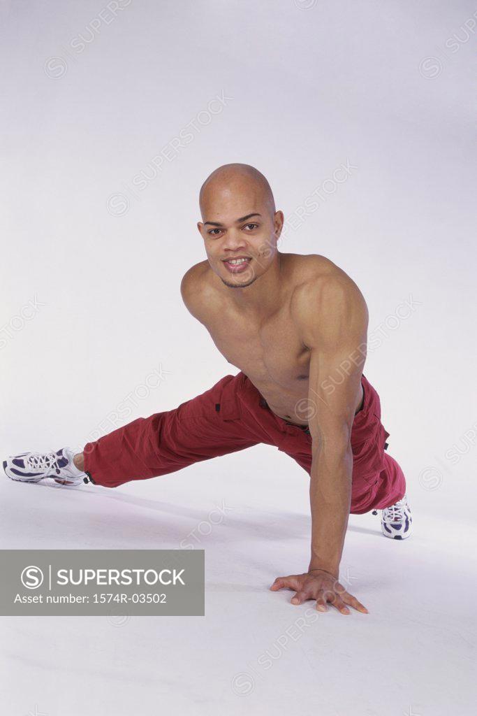 Stock Photo: 1574R-03502 Portrait of a young man doing push-ups